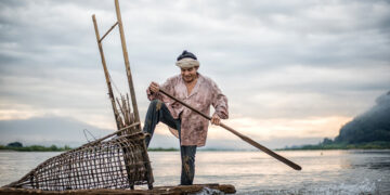 Fisherman on a boat in the Mekong River.