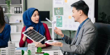Indonesian business team discussing solar energy.