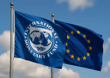Flags of the IMF and the EU against a blue sky background.