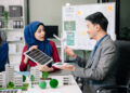 Indonesian business team discussing solar energy.