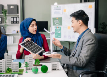 Indonesian business team discussing solar energy.